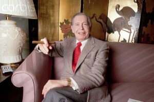 1986 --- Original caption: Portrait of comedian Milton Berle. He is shown seated on a couch, smoking a cigar. Photograph, 1986. --- Image by © Lynn Goldsmith/Corbis